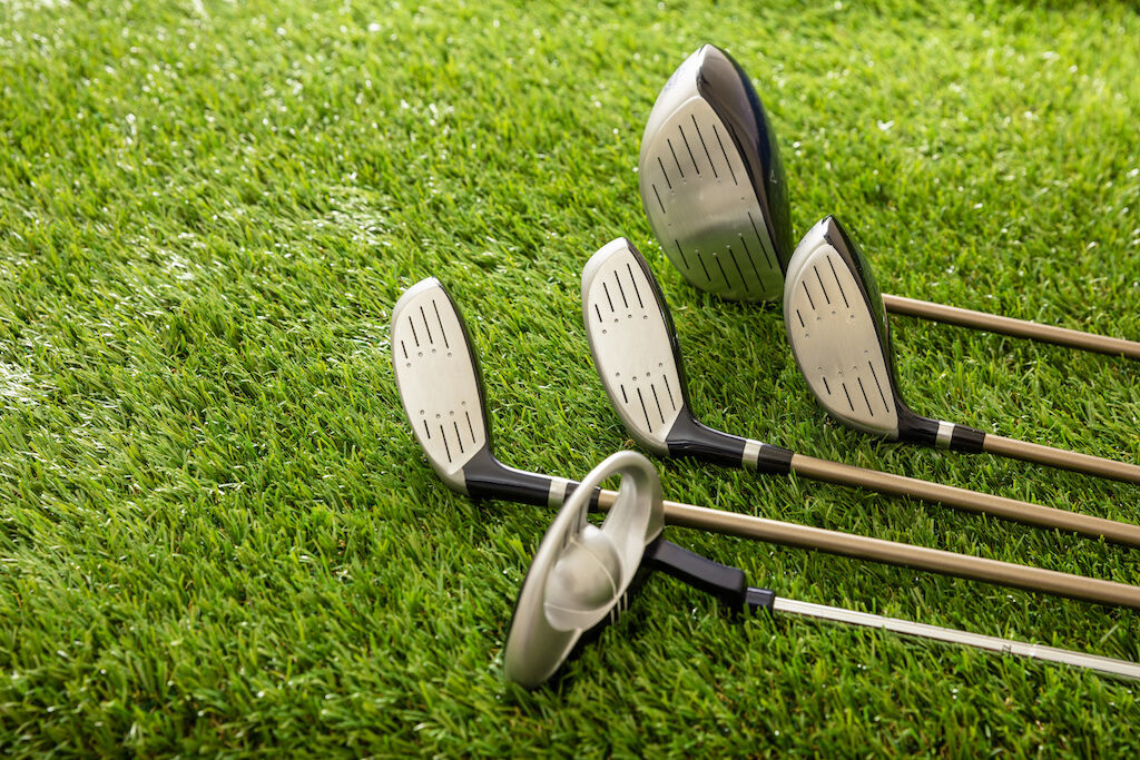 golf-clubs-on-green-grass-golf-course-close-up-vi-2022-10-27-02-51-03-utc.jpg