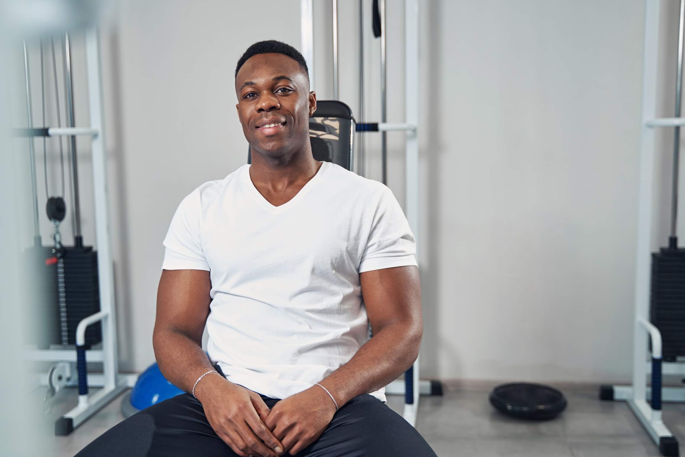 sporty-man-seated-at-gym-looking-ahead-2022-01-11-15-12-52-utc.jpg